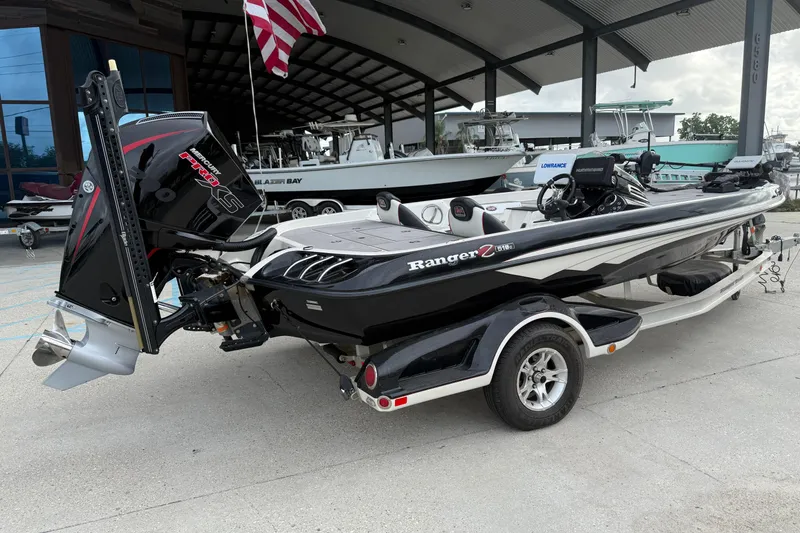Slide: The Image of 2016 Ranger Z518C Intracoastal boat with Mercury Pro XS engine, parked under a canopy. - 3