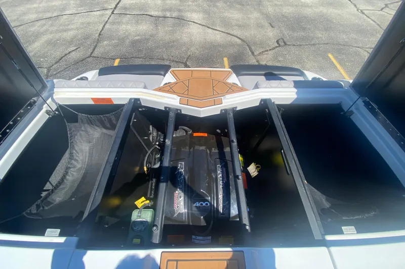 Slide: The Image of 2021 Tigé Z3 boat engine compartment with Raptor motor, open storage hatches. - 12