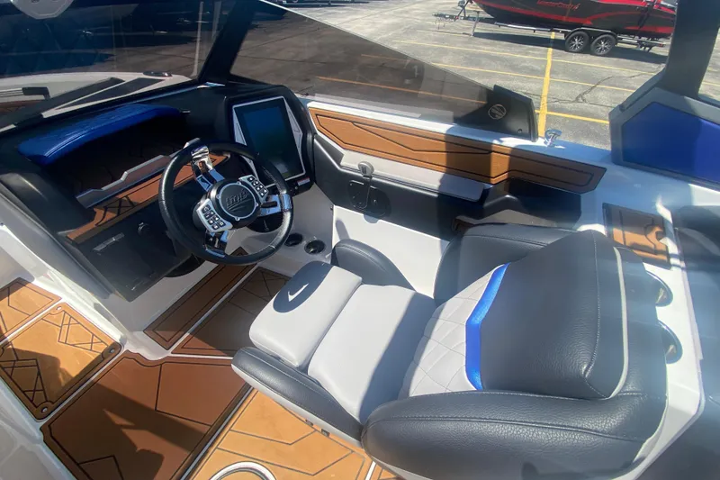 Slide: The Image of 2021 Tigé Z3 boat interior with modern dashboard and luxurious seating. - 19