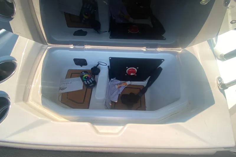 Slide: The Image of Storage compartment in a 2021 Tigé Z3 boat with remote and accessories. - 21