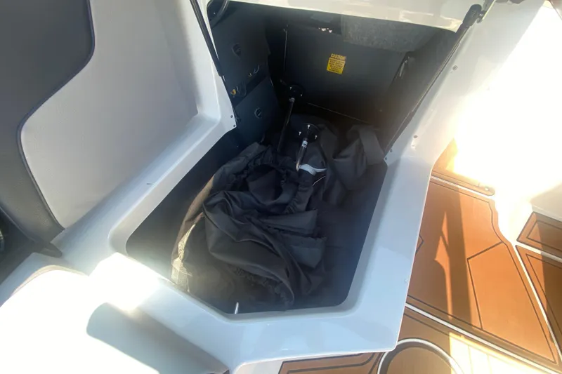 Slide: The Image of Storage compartment in 2021 Tigé Z3 boat with black cover inside. - 25