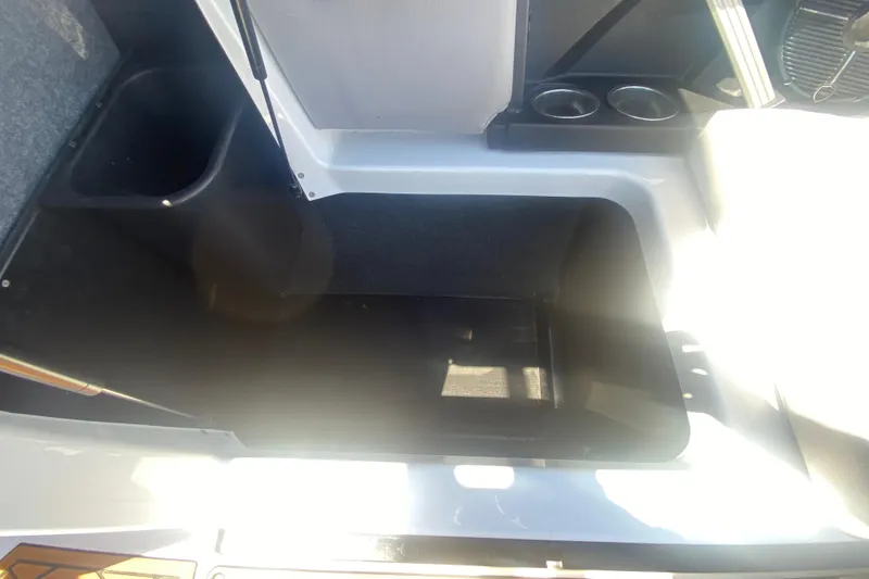 Slide: The Image of 2021 Tigé Z3 boat storage compartment with cup holders and interior view. - 27