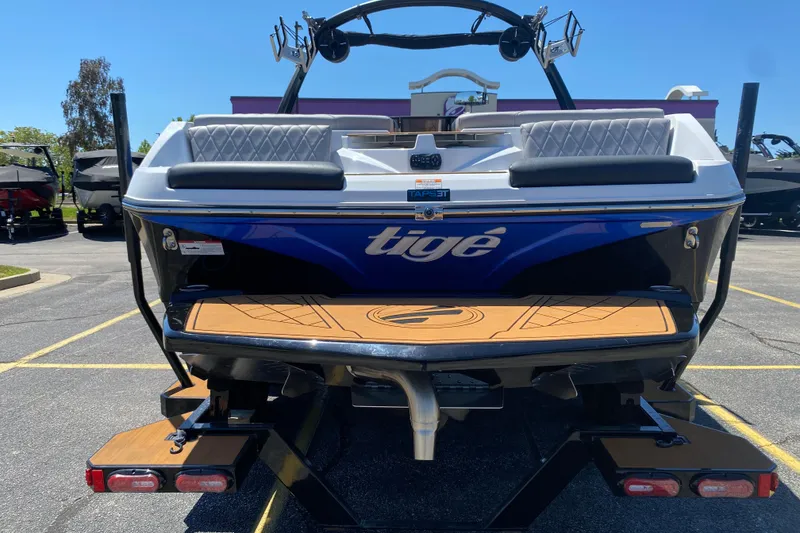 Slide: The Image of 2021 Tigé Z3 boat rear view with teak swim platform in parking lot. - 3