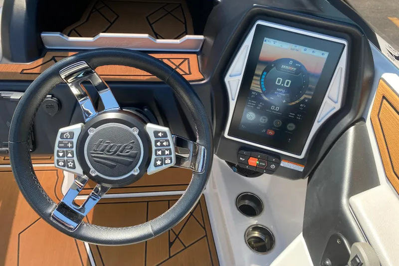 Slide: The Image of 2021 Tigé Z3 boat dashboard with steering wheel and touchscreen display. - 31