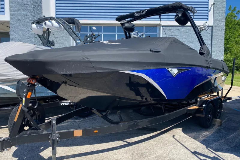 Slide: The Image of 2021 Tigé Z3 boat with cover on trailer, blue and black design. - 32