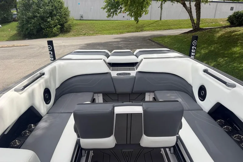 Slide: The Image of 2024 Supra SE 550 boat interior with sleek gray and white seating, outdoor setting. - 13