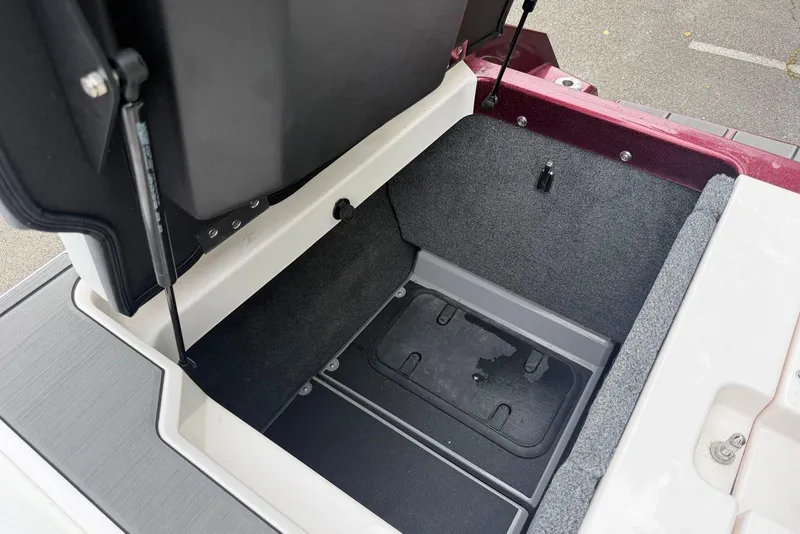 Slide: The Image of Open storage compartment in 2024 Supra SE 550 boat, showcasing spacious interior design. - 16