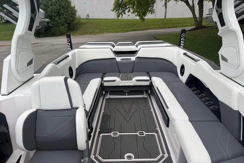 Slide: The Image of 2024 Supra SE 550 boat interior with sleek gray and white seating and modern design. - 9
