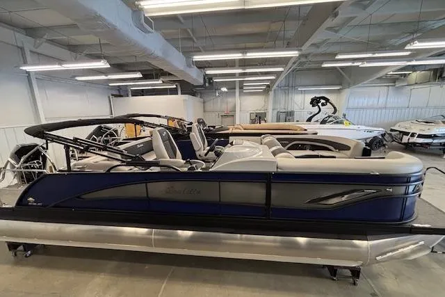 The Image of 2026 Barletta Corsa 23UC pontoon boat displayed in a showroom. - 1