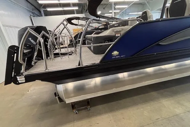 Slide: The Image of 2026 Barletta Corsa 23UC pontoon boat in showroom, featuring sleek design and modern seating. - 2