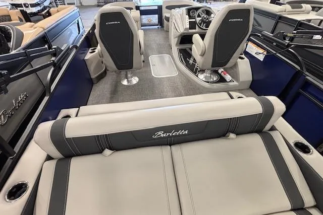 Slide: The Image of 2026 Barletta Corsa 23UC boat interior with seating and steering console. - 23