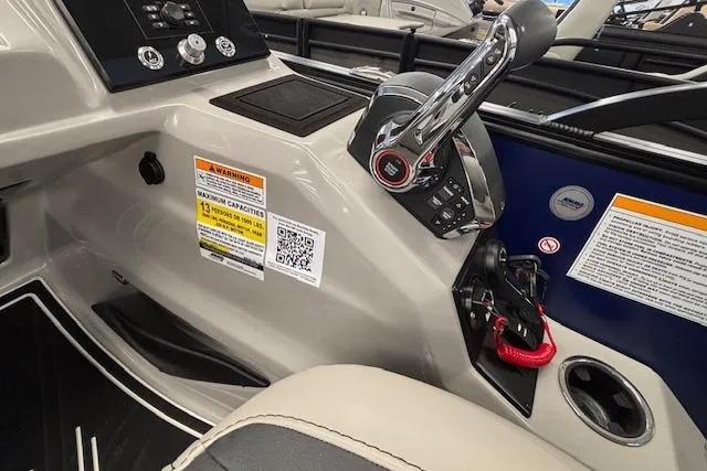 Slide: The Image of Control panel of 2026 Barletta Corsa 23UC boat with throttle and warning labels. - 26