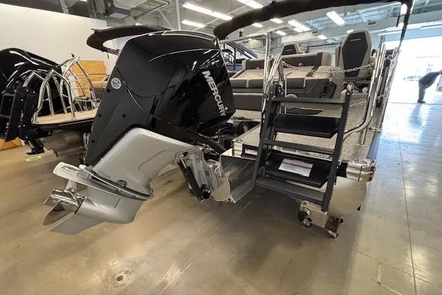 Slide: The Image of 2026 Barletta Corsa 23UC pontoon boat with Mercury outboard motor in showroom. - 3