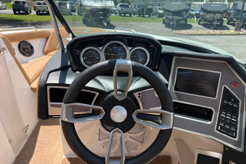 Slide: The Image of 2020 MasterCraft XT25 boat dashboard with steering wheel and control panel. - 10