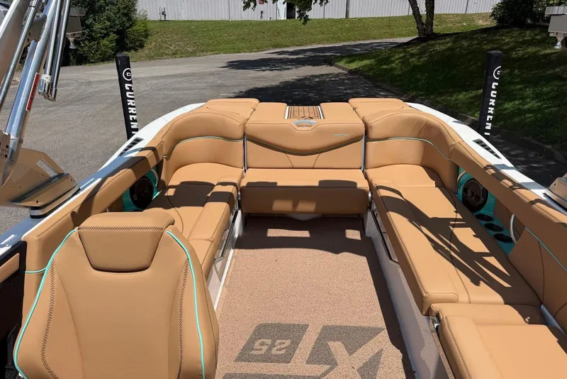 Slide: The Image of 2020 MasterCraft XT25 boat interior with tan seating and modern design. - 13