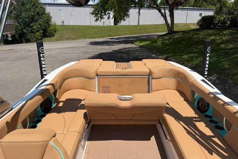 Slide: The Image of 2020 MasterCraft XT25 boat interior with tan seating and modern design. - 14