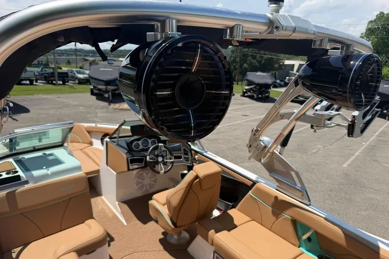 Slide: The Image of 2020 MasterCraft XT25 boat interior with speakers and tan seating. - 16