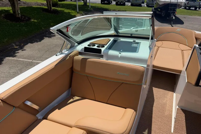 Slide: The Image of 2020 MasterCraft XT25 boat interior with tan leather seating and modern dashboard. - 8