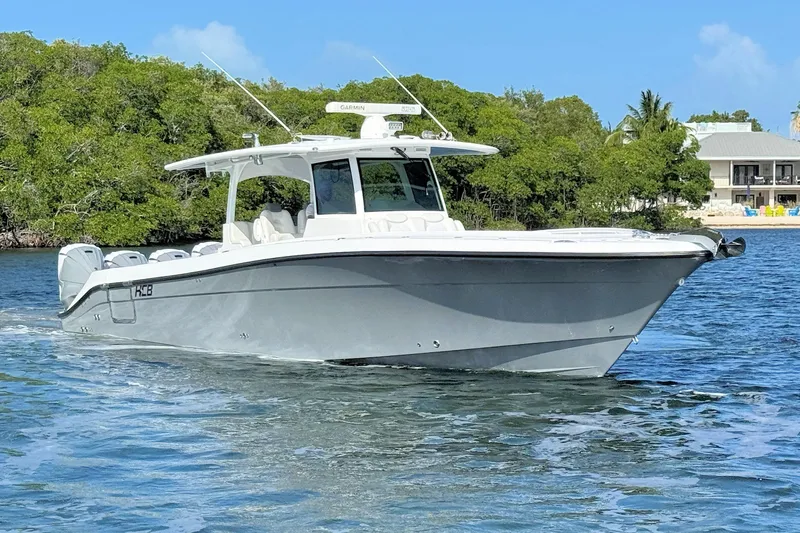 The Image of 2020 HCB 42 Siesta boat cruising on a sunny day near lush greenery. - 1