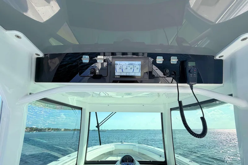 Slide: The Image of 2020 HCB 42 Siesta boat cockpit with navigation equipment and ocean view. - 11