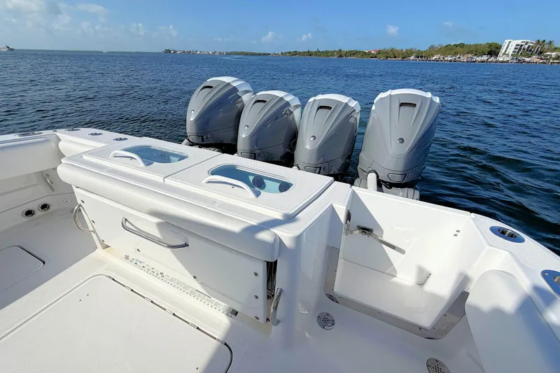 Slide: The Image of 2020 HCB 42 Siesta boat with four powerful outboard engines on a sunny day. - 15