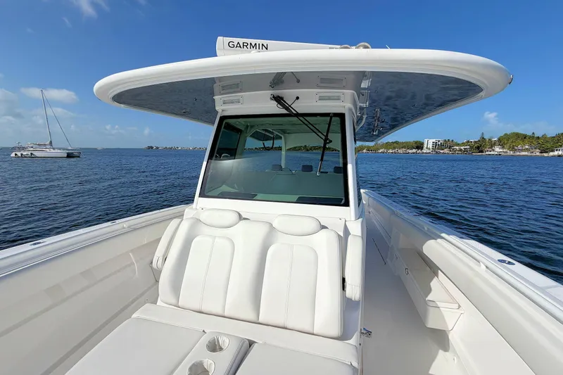 Slide: The Image of 2020 HCB 42 Siesta boat on water, featuring sleek design and Garmin equipment. - 23