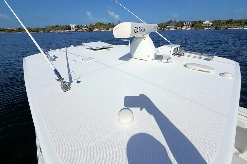 Slide: The Image of 2020 HCB 42 Siesta boat deck with Garmin equipment, overlooking calm waters and distant shoreline. - 25