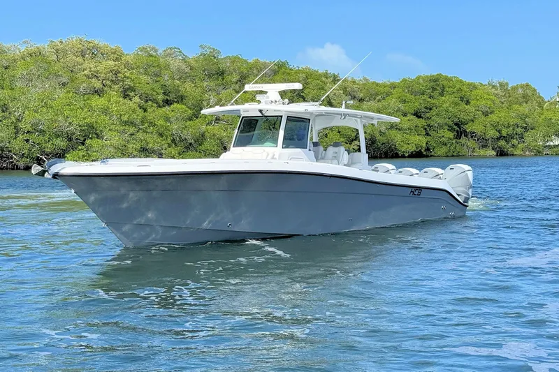 Slide: The Image of 2020 HCB 42 Siesta boat cruising on a calm, scenic waterway. - 3