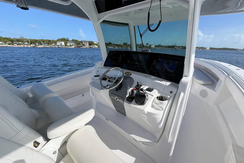 Slide: The Image of 2020 HCB 42 Siesta boat cockpit with modern controls and scenic water view. - 6
