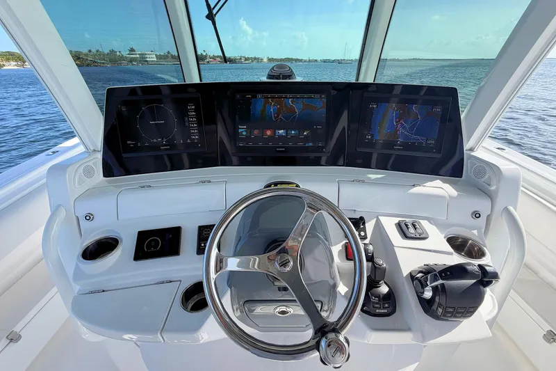 Slide: The Image of Helm of 2020 HCB 42 Siesta boat with advanced navigation displays and controls. - 7