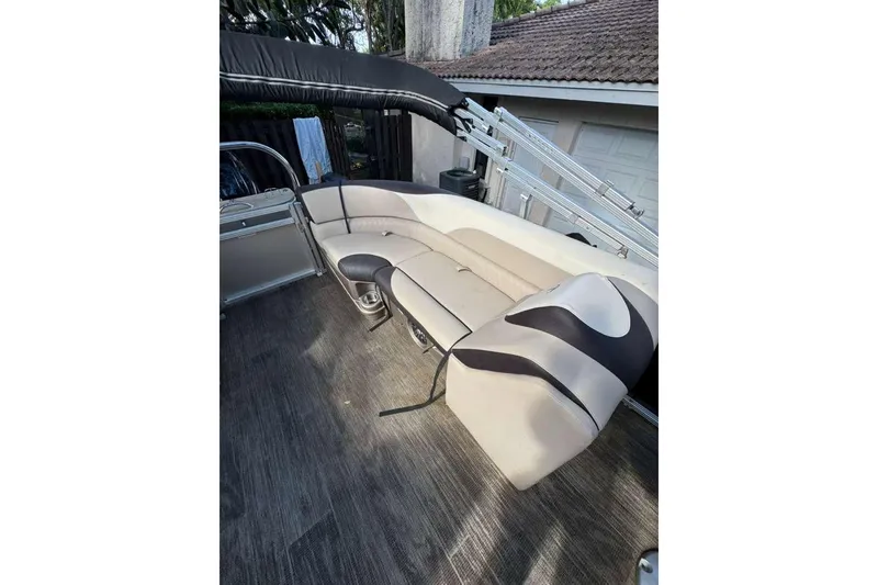 Slide: The Image of 2023 Tahoe Pontoon LTZ 2385 QUAD LOUNGE with beige and black seating. - 4