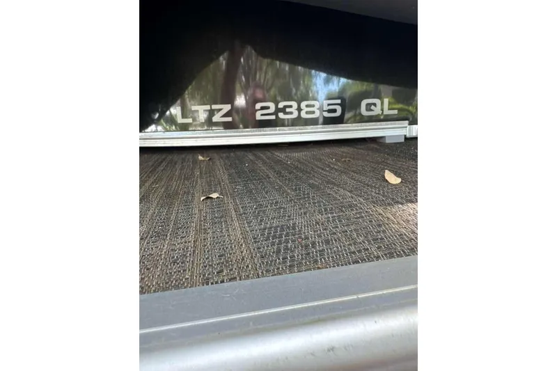 Slide: The Image of 2023 Tahoe Pontoon LTZ 2385 Quad Lounge model nameplate on boat exterior. - 6