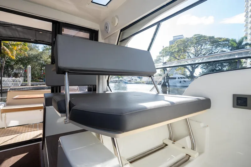 Slide: The Image of Interior of 2021 Beneteau Antares 9 boat with modern seating and waterfront view. - 32