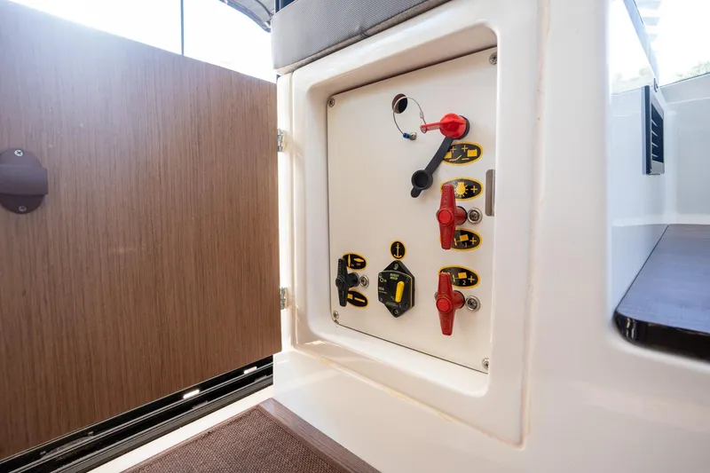 Slide: The Image of Control panel inside 2021 Beneteau Antares 9 boat, featuring switches and indicators. - 33