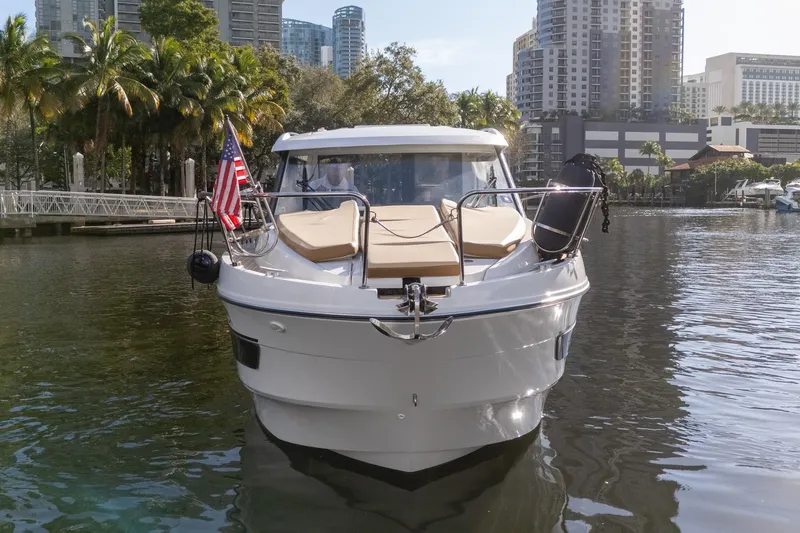Slide: The Image of 2021 Beneteau Antares 9 boat docked in urban marina with cityscape background. - 7
