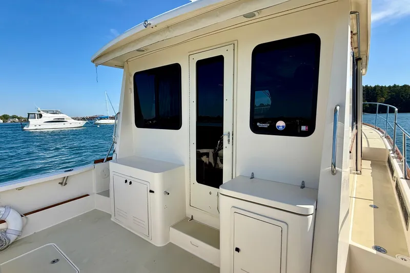 Slide: The Image of 2006 Sabre 42 Sedan yacht deck with ocean view and nearby boats. - 24