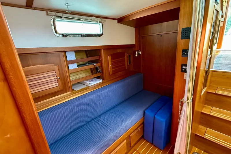 Slide: The Image of Interior of 2006 Sabre 42 Sedan with blue seating and wooden cabinetry. - 37