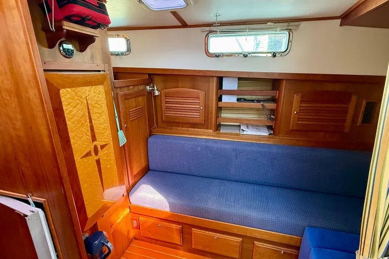 Slide: The Image of Interior of 2006 Sabre 42 Sedan with wooden cabinetry and blue seating. - 36