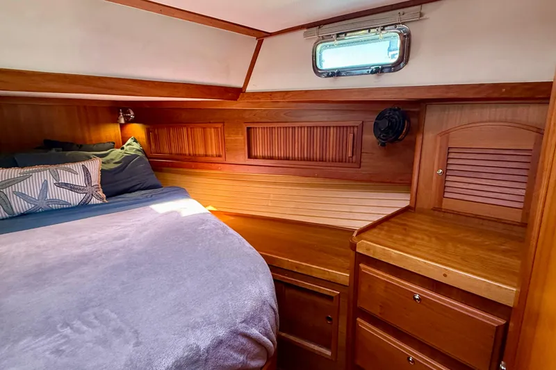 Slide: The Image of Cozy cabin interior of 2006 Sabre 42 Sedan with wooden furnishings and bed. - 29