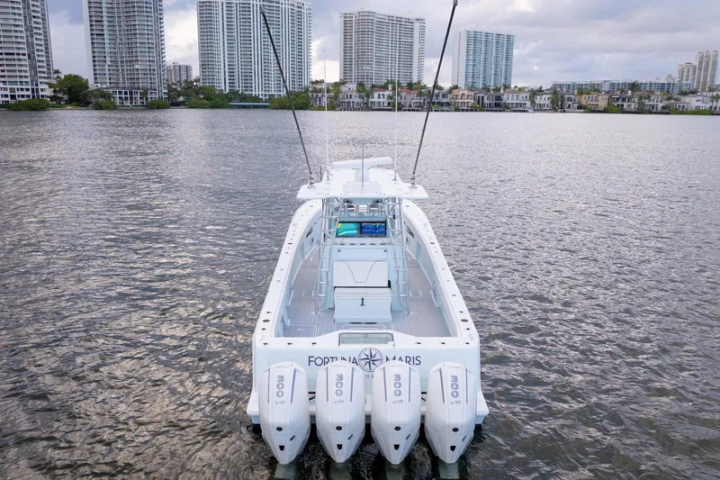 Slide: The Image of 2023 SeaVee 390Z boat with quad engines on a calm urban waterfront. - 10