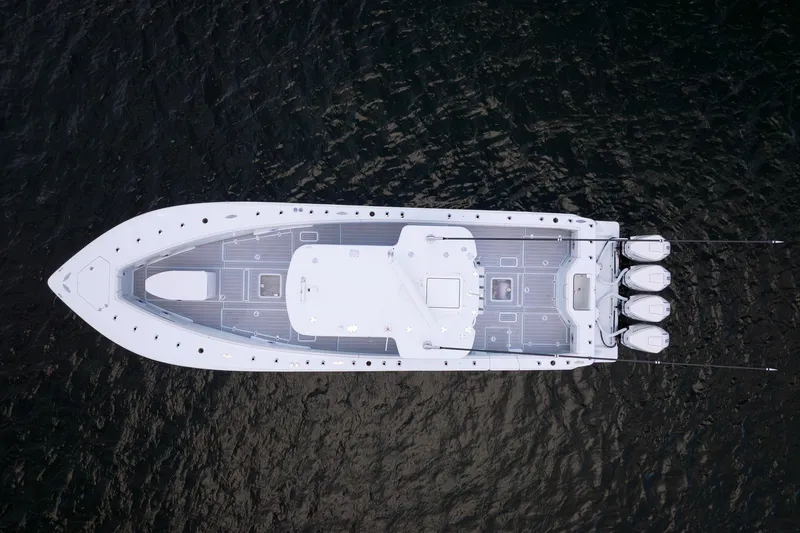 Slide: The Image of Aerial view of 2023 SeaVee 390Z boat with triple engines on dark water. - 11