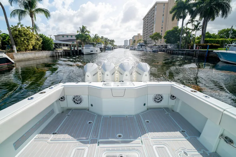Slide: The Image of 2023 SeaVee 390Z boat with Mercury engines, docked in a scenic canal setting. - 15