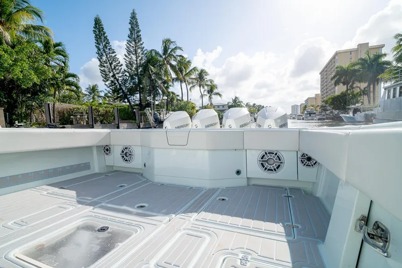 Slide: The Image of 2023 SeaVee 390Z boat deck with multiple outboard engines, surrounded by tropical scenery. - 17