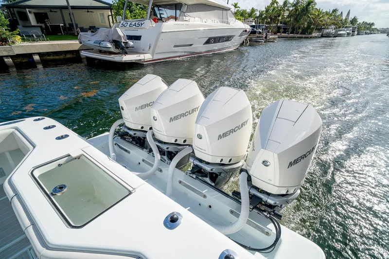 Slide: The Image of 2023 SeaVee 390Z boat with four Mercury outboard engines on a sunny waterway. - 25