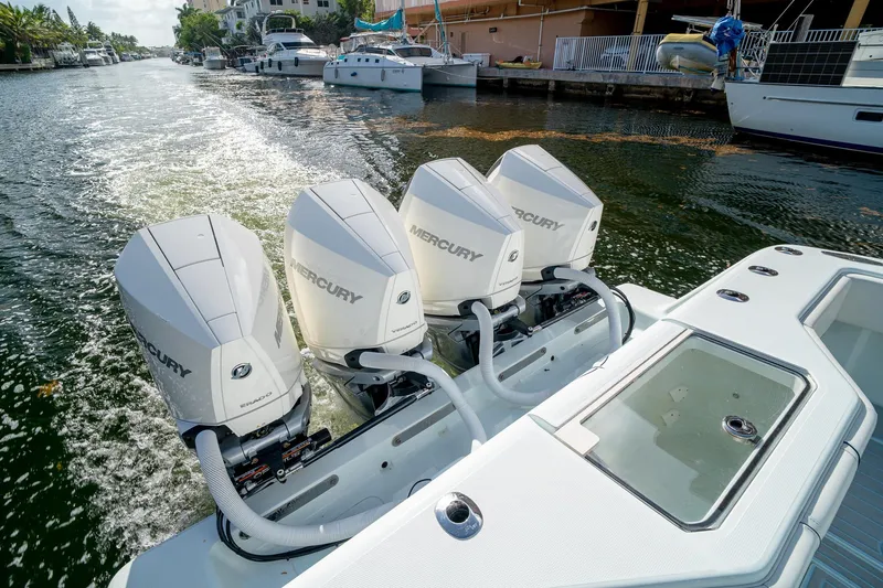 Slide: The Image of 2023 SeaVee 390Z boat with four Mercury outboard engines on a canal. - 27
