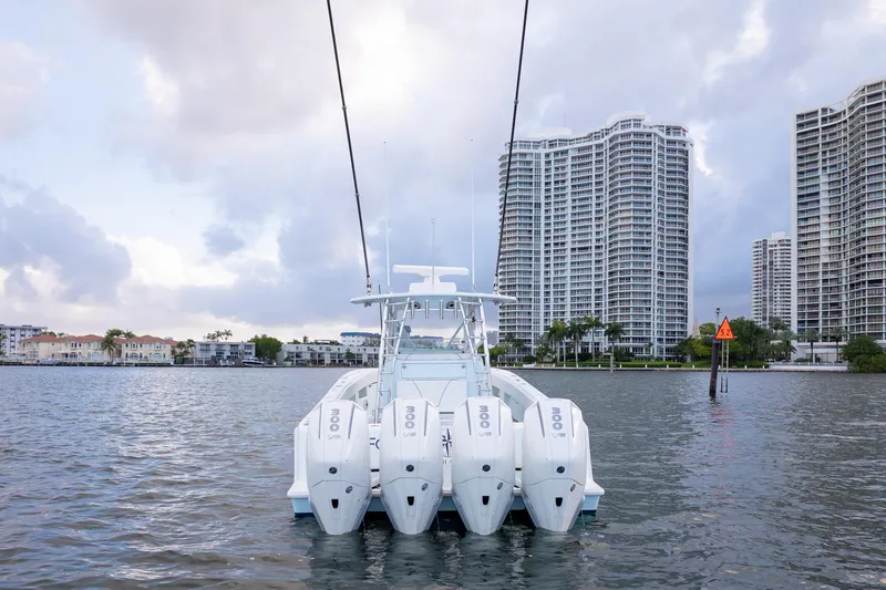 Slide: The Image of 2023 SeaVee 390Z boat with four engines on water, city skyline in background. - 3