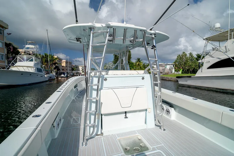 Slide: The Image of 2023 SeaVee 390Z boat docked in a marina, showcasing sleek design and modern features. - 32