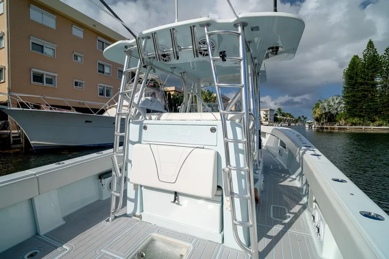 Slide: The Image of 2023 SeaVee 390Z boat docked, showcasing sleek design and spacious deck. - 34