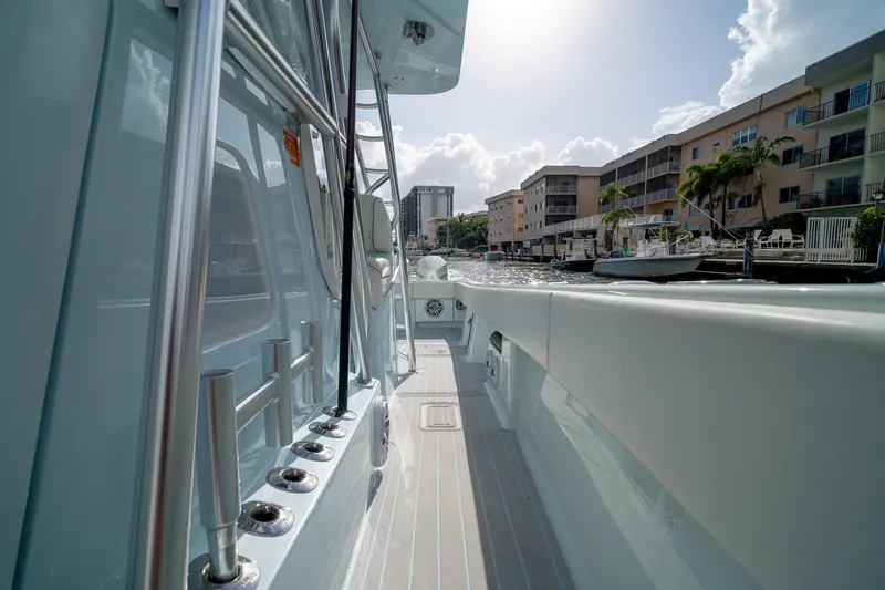 Slide: The Image of 2023 SeaVee 390Z boat docked near waterfront buildings under a sunny sky. - 36