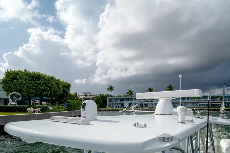 Slide: The Image of 2023 SeaVee 390Z boat with radar equipment under cloudy sky near waterfront. - 37